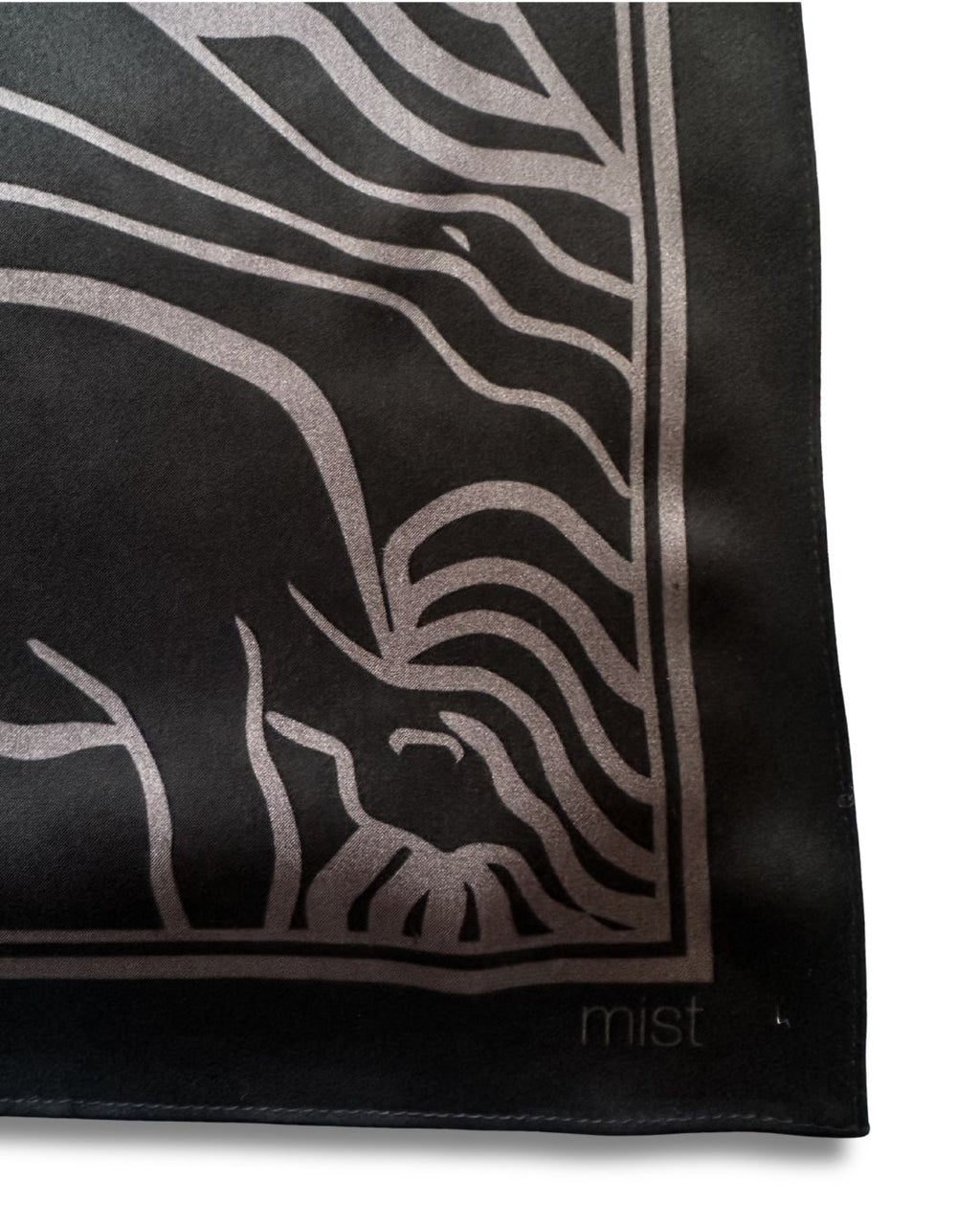 Black silk scarf with ladies pattern and 'mist' branding on a white background